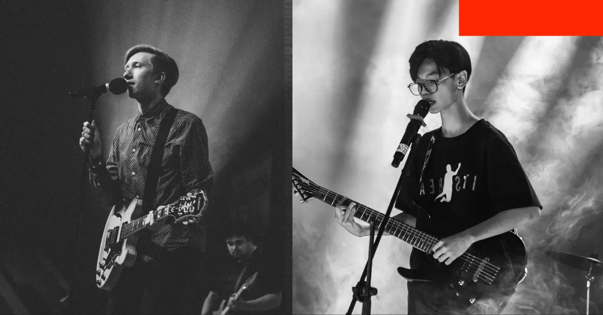 A man strumming a guitar alongside another man singing, capturing a moment of musical collaboration.